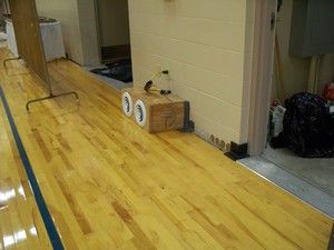 Blowers installed for the dryout process on a wet, cupped gymnasium floor Photo for project